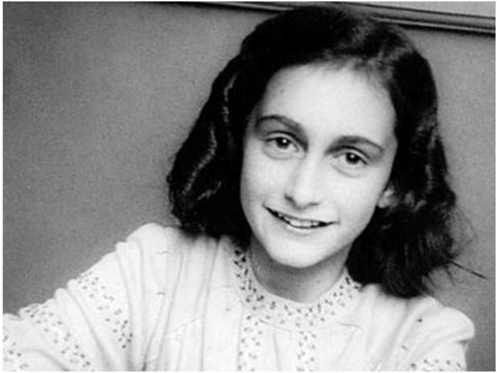 Black and white portrait of Anne Frank: young girl with black shoulder-length hair, smiling at the camera